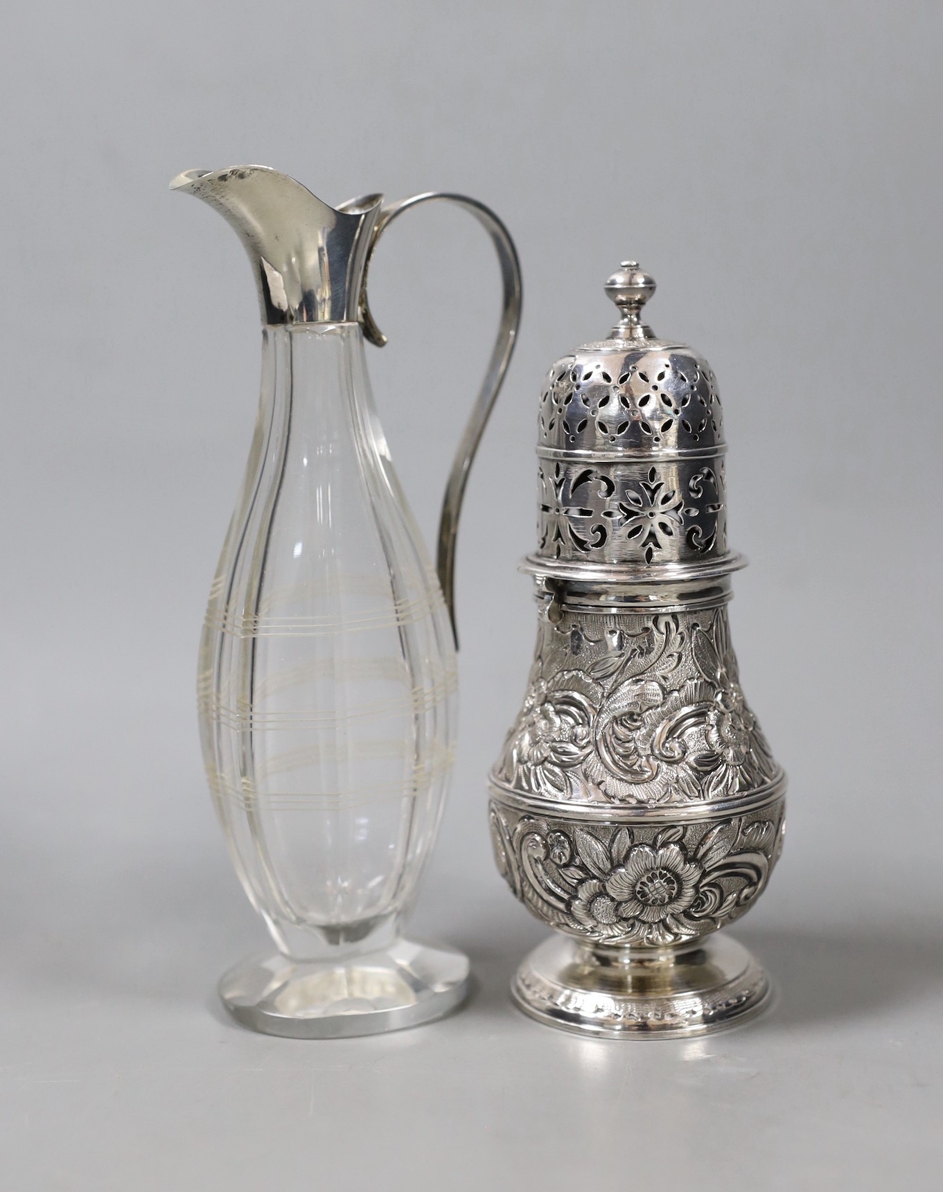 A continental white metal baluster caster (top and base associated), 14.2cm and a 1920's silver mounted condiment bottle.